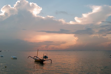 Beautiful sunrise on the bank of coast of the city of Sanur to Bali.の写真素材