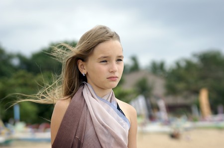 The most beautiful schoolgirl of Borneo travels across Bali. The sea. A beach.の写真素材