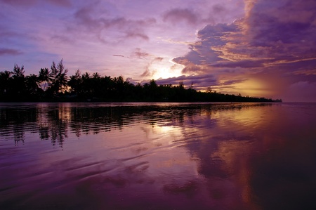 Sea sunset at stony sea coast of Rambungan. Borneo. 