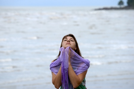 The young beautiful girl in a bathing suit bathes in South China sea on island Borneo peninsula Santubong.の写真素材