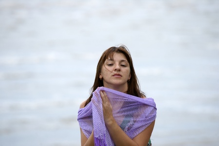 The young beautiful girl in a bathing suit bathes in South China sea on island Borneo peninsula Santubong.の写真素材