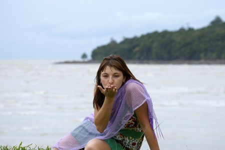 The young beautiful girl in a bathing suit bathes in South China sea on island Borneo peninsula Santubong.の写真素材