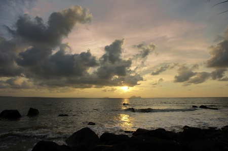 Sea sunset at stony seacoast of Santubong. Borneo. の写真素材
