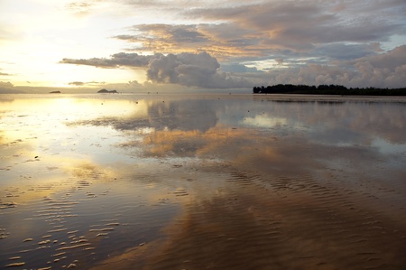 Sea sunset at stony sea coast of peninsula Santubong. Borneo. 