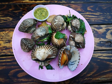 Steamed blanched clams with dipping sauce.
