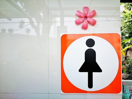 cute flowers for decorations and woman icon on front of  toiletの写真素材