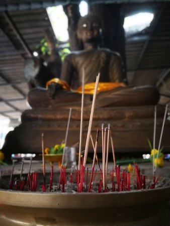 Incense and candlelight for worship from Buddhist in Thailand Templeの写真素材
