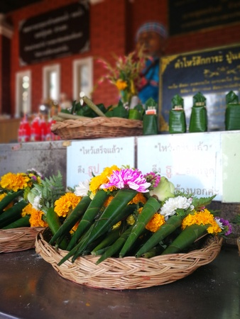incense candles flowers cigarettes and  ceramic dolls  for Buddha statue and Thailand text were words to pray godのeditorial素材
