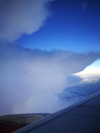 a storm cloud in the sky from airplane windows viewの写真素材