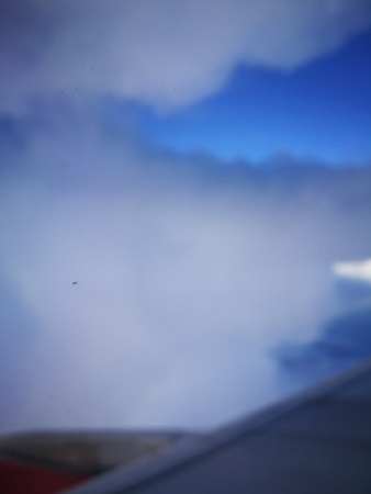 a storm cloud in the sky from airplane windows viewの写真素材