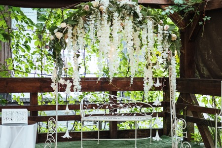 Wedding arch decorated with hanging flowersの写真素材