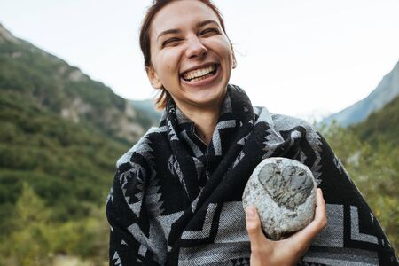A young woman holding a stone in her handの写真素材