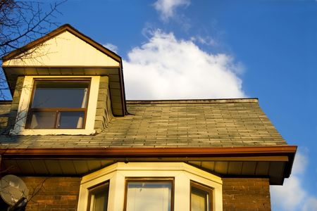 Roofs and clouds on sunset