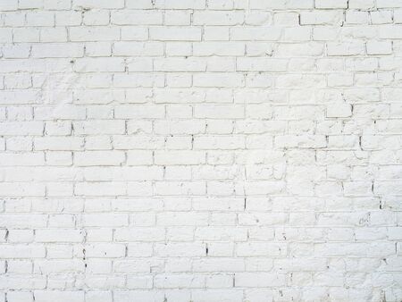 texture: old cracked brick wall painted in white paint