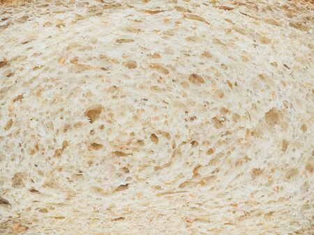 texture of slices of white bread with bran closeupの写真素材