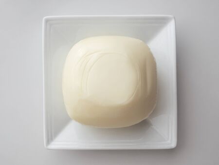 mozzarella cheese on a square white plateの写真素材