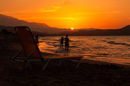 Sunbed on the beach at sunset. Creteの写真素材