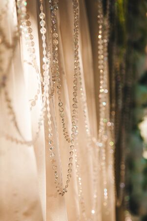 threads with rhinestones on fabric, light and shadow, bokeh - abstract backgroundの写真素材