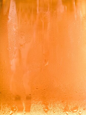 blurred background - misted glass with light beerの写真素材