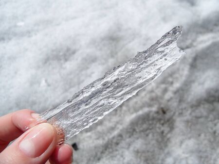 fragment of ice in the hands of winter Baikal in Siberiaの写真素材