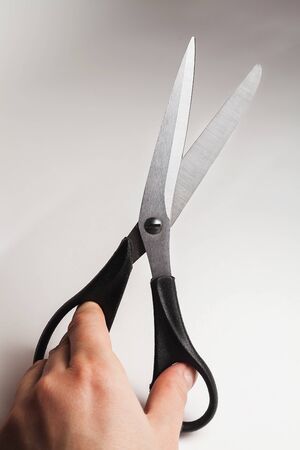 metal tailor sewing scissors with black big and small rings in handの写真素材