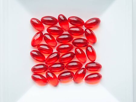 ed capsules - medication on a white plate close upの写真素材