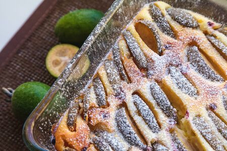 feijoa curd cake decorated with icing sugar in a glass formの写真素材