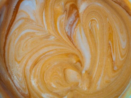 abstract background orange-beige cream stains in a plateの写真素材