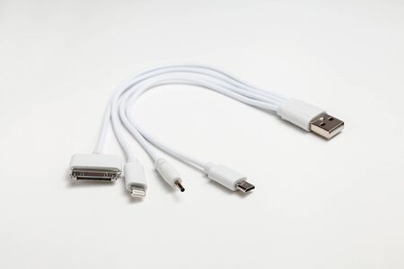 white universal charging cable, adapter with micro USB, usb connectors for different models of phones and devices on a white backgroundの写真素材