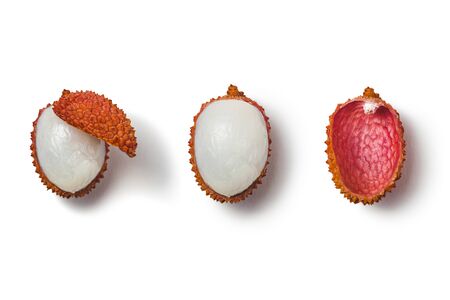 One ripe, half-peeled pink-red lychee on a white background with shadow. Side viewの写真素材