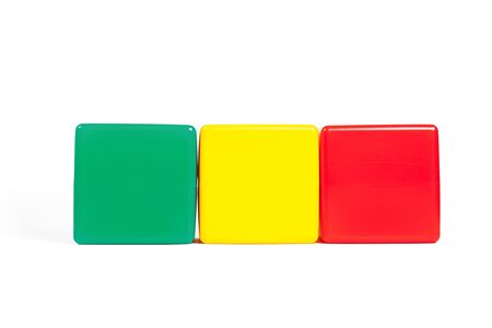 Mali flag colors: green, yellow, red in the form of children's cubes. On white background isolated with shadowの写真素材