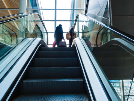 Rostov-on-Don, Russia - March 15, 2020: escalator and passengers at the Platov International Airportのeditorial素材