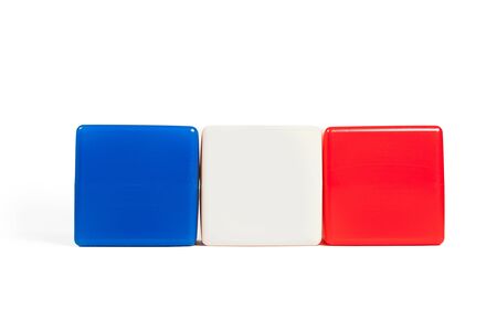 colors of the flag of France: blue, white, red in the form of children's cubes. On white background isolated with shadowの写真素材