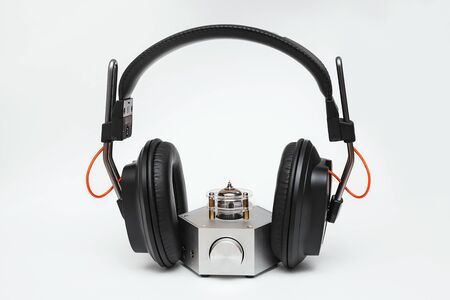 headphone tube amplifier and isodynamic full-size closed headphones on a white backgroundの写真素材