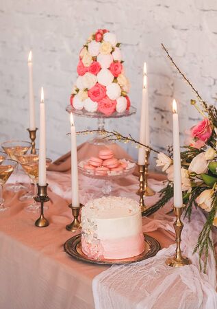 wedding cake with flowers macaroons candles marshmallowの写真素材