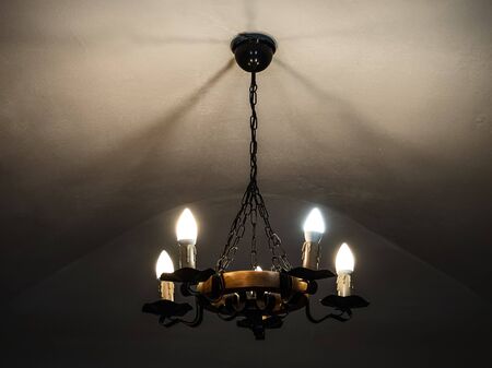 vintage chandelier shines in the dark in the castleの写真素材