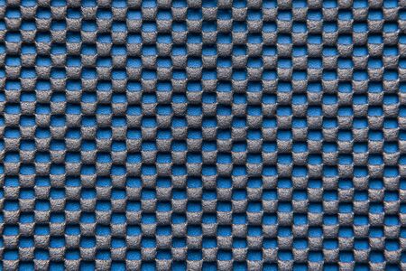 Abstract black and blue background - chess pattern. Anti-slip mat on a blue backgroundの写真素材