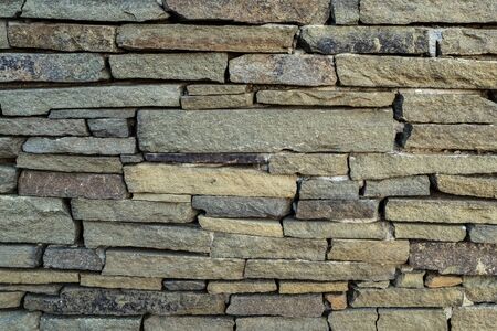 old wall of stones of different sizes close-up - backgroundの写真素材
