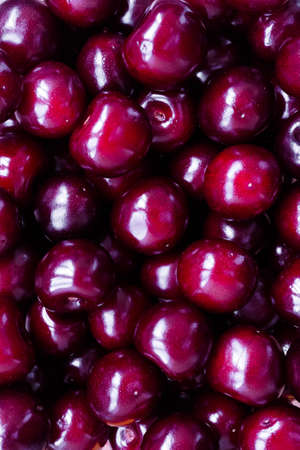 Appetizing shiny ripe sweet cherry. Large maroon berries - food vertical backgroundの写真素材