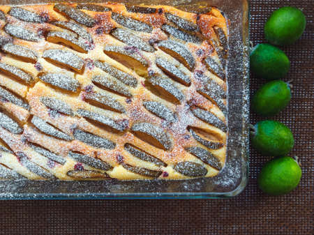 feijoa curd cake decorated with icing sugar in a glass form, top viewの写真素材