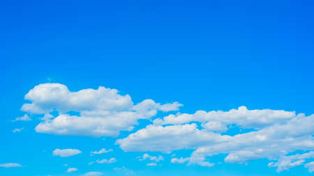 beautiful white clouds in the sky, horizontal gradient from light blue to darkの写真素材