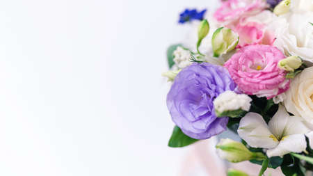 beautiful bouquet of multi-colored eustomas close-up, copy space. Focus on the petals, white background blurredの写真素材