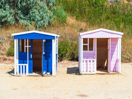two wooden houses for children to play on the playground - for boys and girlsの写真素材