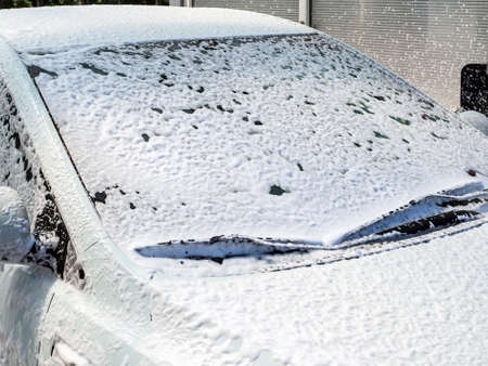 foam on the windshield at a car washの写真素材