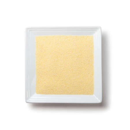 semolina on white square plate on white background with shadow isolatedの写真素材