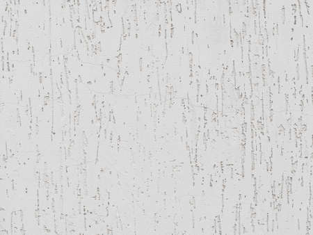 cracks and pits in white stucco on the wall - textureの写真素材
