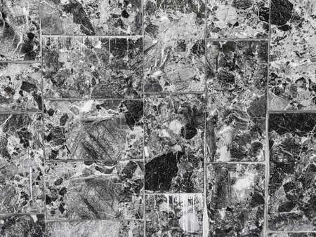 texture of large marble tiles with gray and black spots - building wall decorationの写真素材