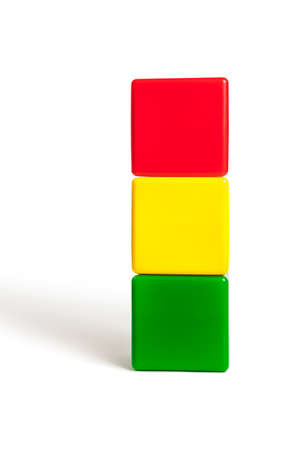 flag colors of Bolivia: red, yellow, green in the form of children's cubes. On white background isolated with shadowの写真素材