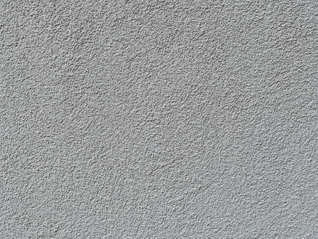 part of a relief concrete wall with spots - surface textureの写真素材