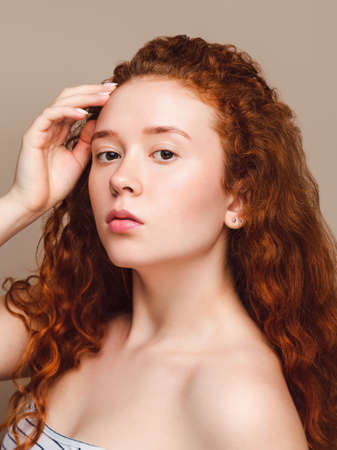 Portrait of a young attractive Scandinavian girl with red hair and freckles. Natural beauty.の写真素材